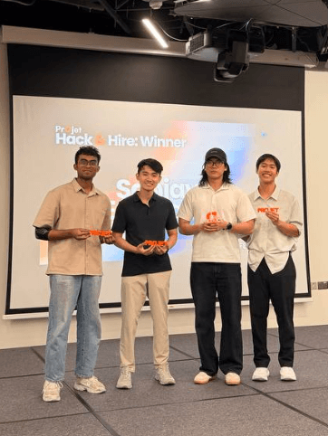 Emmanuel and three teammates on stage after winning Projet Hack & Hire 2026