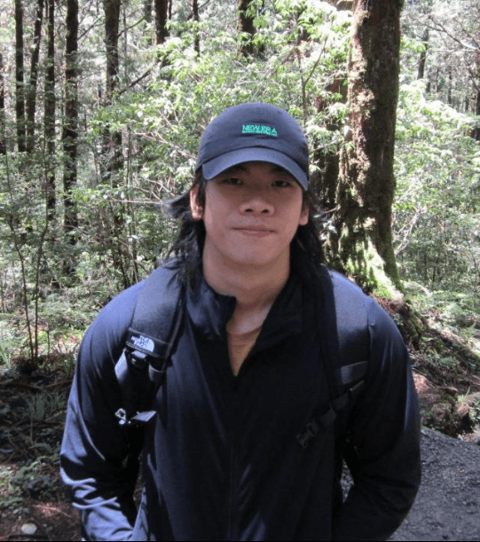 Emmanuel Tan standing on a forest trail